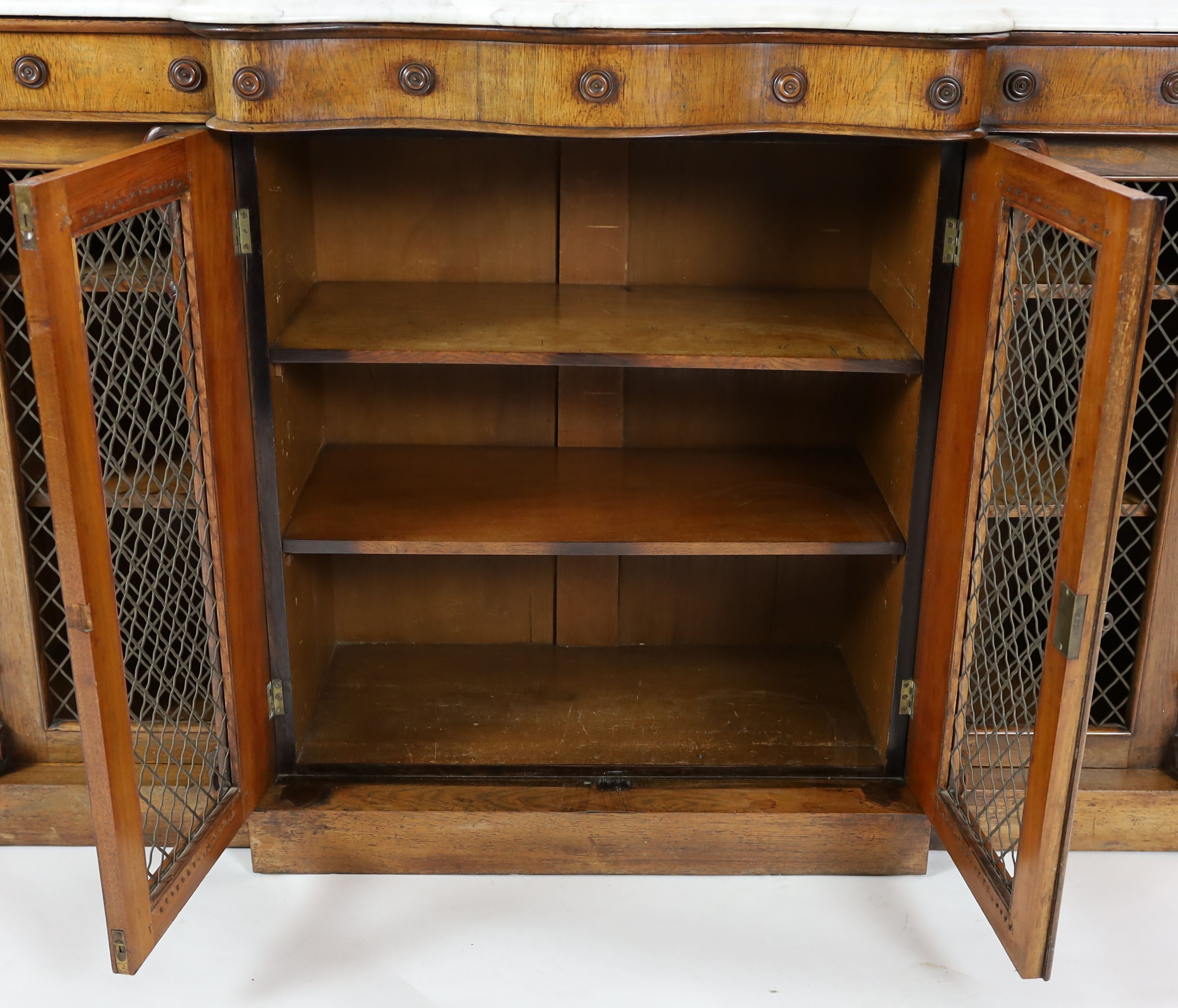 A Victorian rosewood serpentine dwarf bookcase, W.154cm D.44cm H.97cm